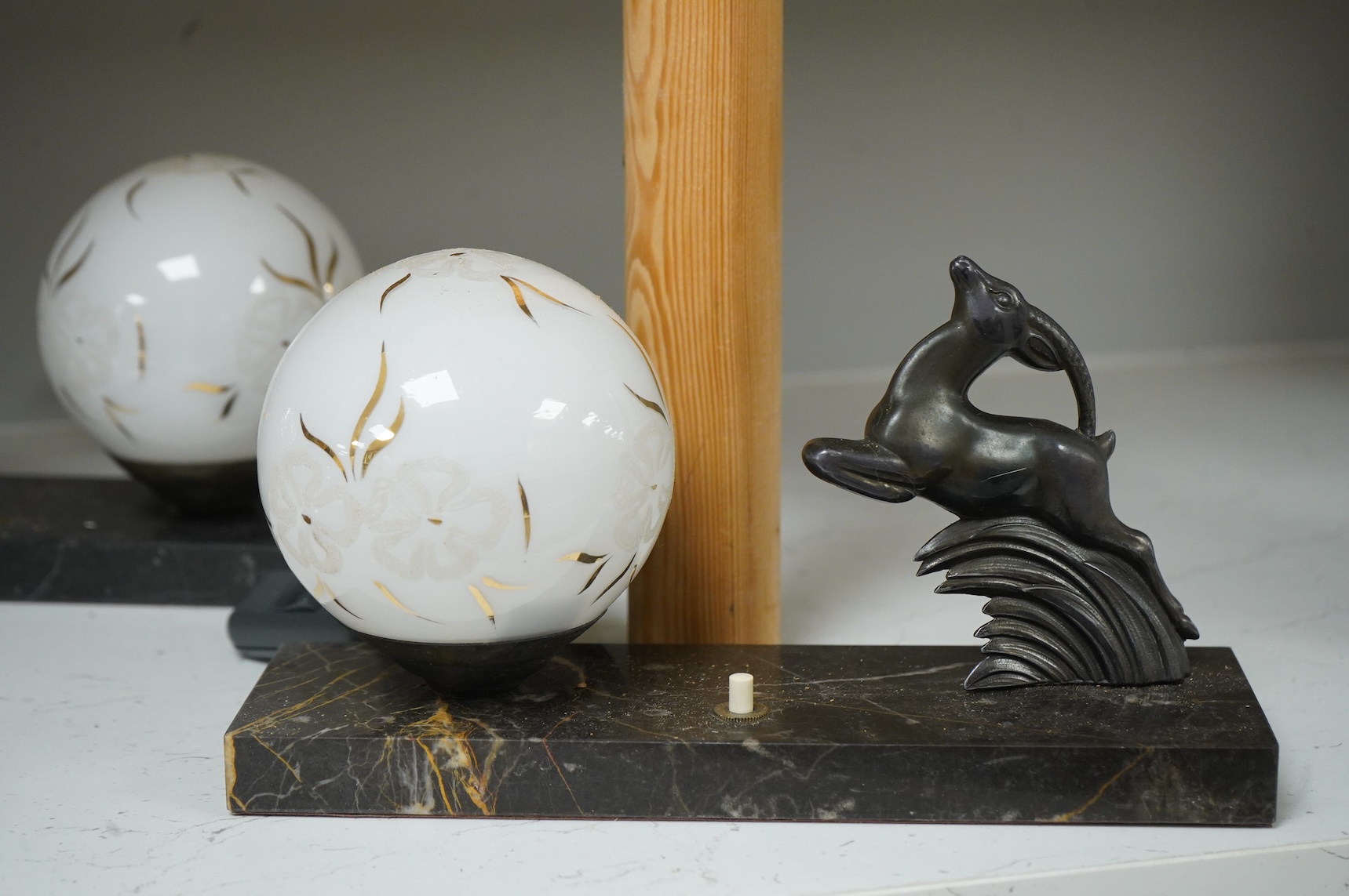 A pair of French Art Deco stag bookends, a chrome Greyhound mounted on a marble base, a large Arts and Crafts copper jug and two other items, jug 27cm high